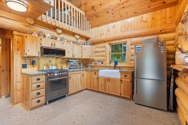 1543 E Miners Lk, Ely, MN 55731 - kitchen featuring appliances with stainless steel finishes, a sink, rustic walls, light stone countertops, and light brown cabinetry