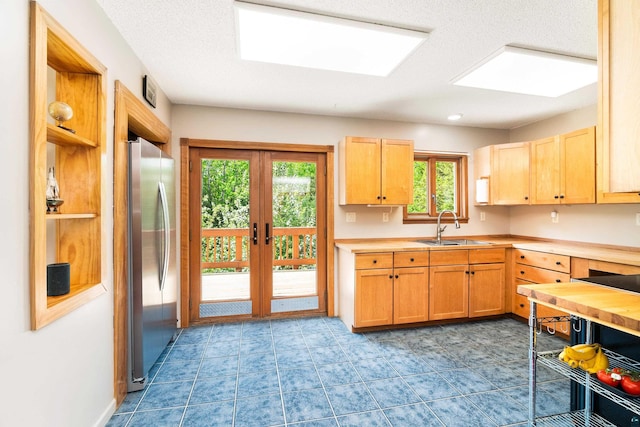 1682 Old N Shore Rd, Duluth, MN 55804 - kitchen with freestanding refrigerator, a sink, french doors, light countertops, and light brown cabinetry