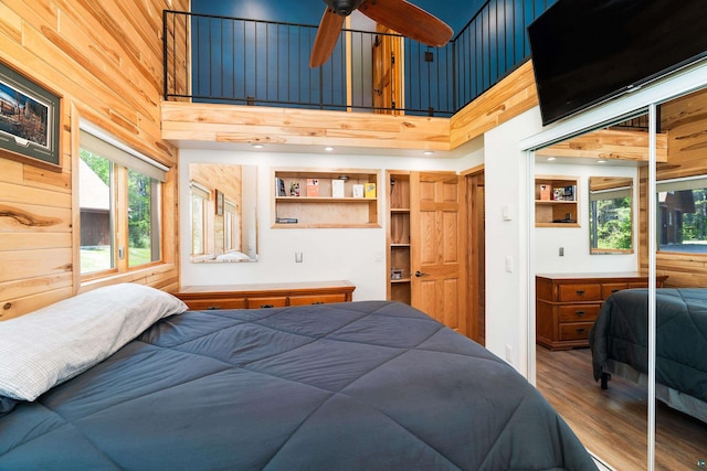 1682 Old N Shore Rd, Duluth, MN 55804 - bedroom featuring a high ceiling, wood finished floors, and wooden walls