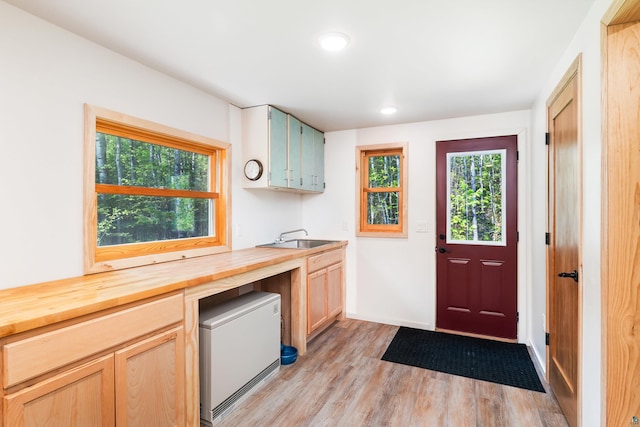 1682 Old N Shore Rd, Duluth, MN 55804 - kitchen with butcher block countertops, a sink, light wood finished floors, healthy amount of natural light, and recessed lighting