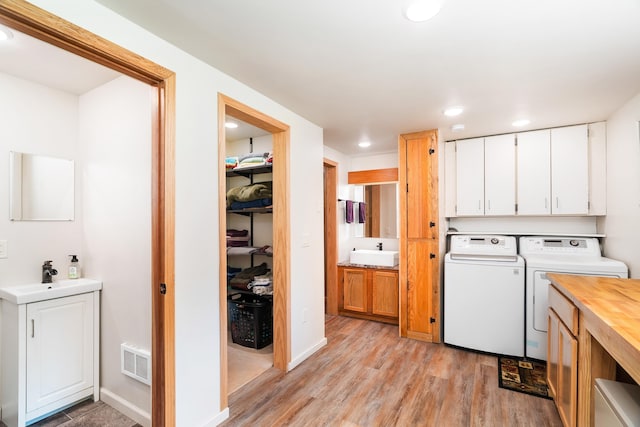 1682 Old N Shore Rd, Duluth, MN 55804 - washroom featuring washer and dryer, light wood-style flooring, and recessed lighting