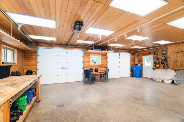 1682 Old N Shore Rd, Duluth, MN 55804 - garage with a workshop area, wood walls, and wooden ceiling