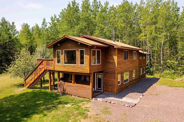 1682 Old N Shore Rd, Duluth, MN 55804 - chalet / cabin with a front yard, stairway, a wooden deck, and a wooded view