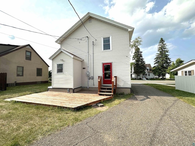 638 E James St, Ely, MN 55731 - rear view of property with a lawn and a wooden deck