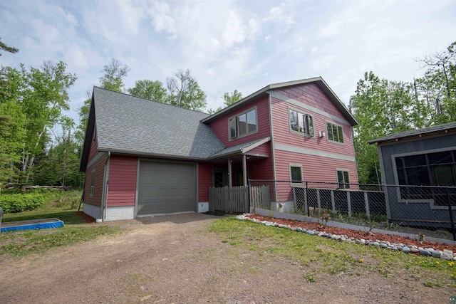 23 Senty Rd, Grand Marais, MN 55604 - view of front of house with driveway, a garage, and a shingled roof