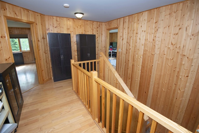23 Senty Rd, Grand Marais, MN 55604 - corridor featuring an upstairs landing, light wood-style floors, and wood walls