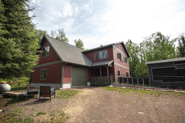 23 Senty Rd, Grand Marais, MN 55604 - view of front of property with dirt driveway, roof with shingles, and a garage
