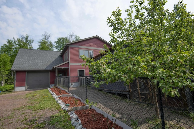 23 Senty Rd, Grand Marais, MN 55604 - view of front facade featuring driveway, an attached garage, and roof with shingles