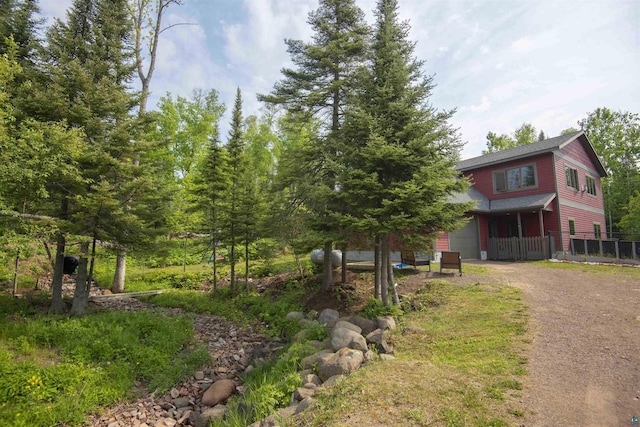 23 Senty Rd, Grand Marais, MN 55604 - view of front of home featuring dirt driveway and a garage