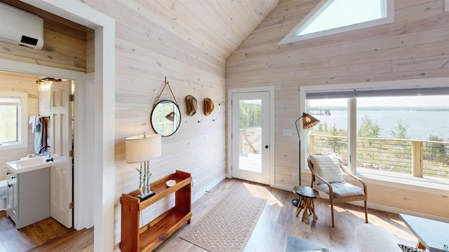 12157 Gunflint Trl, Grand Marais, MN 55604 - doorway with wood walls, light wood-style flooring, a water view, a sink, and wooden ceiling