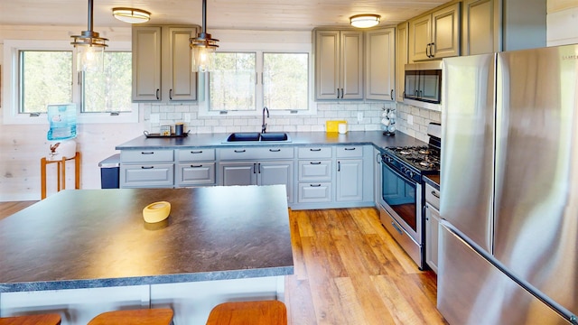 12157 Gunflint Trl, Grand Marais, MN 55604 - kitchen featuring stainless steel appliances, a sink, dark countertops, light wood finished floors, and wood ceiling