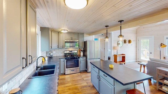 12157 Gunflint Trl, Grand Marais, MN 55604 - kitchen with stainless steel appliances, a sink, dark countertops, tasteful backsplash, and wooden ceiling