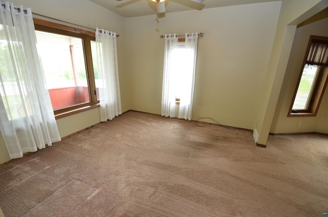 1201 N 59th Ave W, Duluth, MN 55807 - spare room featuring light colored carpet, healthy amount of natural light, and a ceiling fan