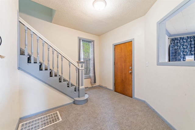 30 N 25th Ave W, Duluth, MN 55806 - foyer entrance featuring carpet, stairway, and a textured ceiling