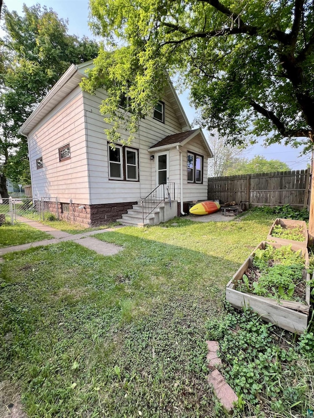 6512 Raleigh St, Duluth, MN 55807 - rear view of property featuring a garden