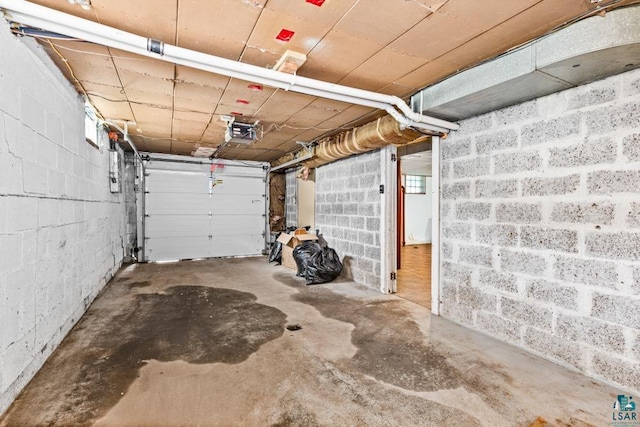 1155 Brainerd Ave, Duluth, MN 55803 - garage featuring a garage door opener and concrete block wall