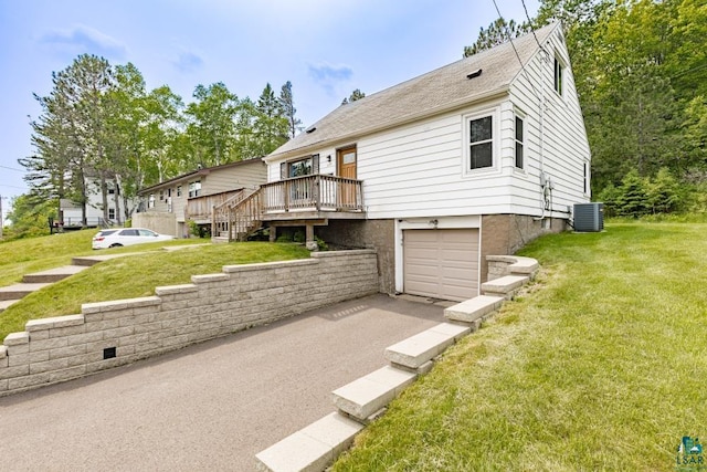 1155 Brainerd Ave, Duluth, MN 55803 - view of front of house featuring an attached garage, a front yard, a deck, and asphalt driveway
