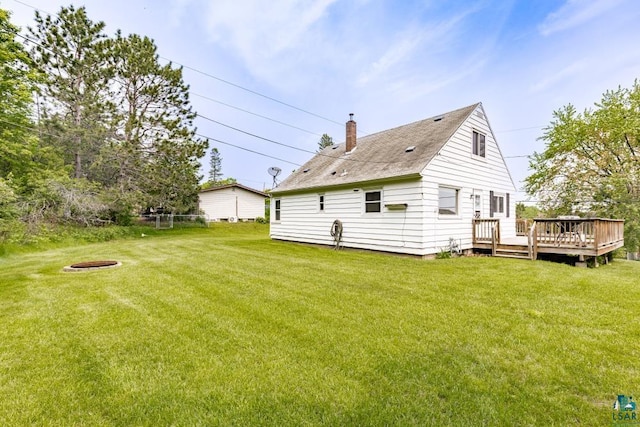 1155 Brainerd Ave, Duluth, MN 55803 - rear view of house featuring a wooden deck, a chimney, a yard, and a fire pit