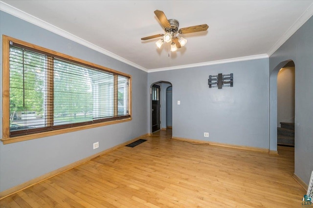 117 W Toledo St, Duluth, MN 55811 - unfurnished room with arched walkways, wood finished floors, a ceiling fan, ornamental molding, and stairway