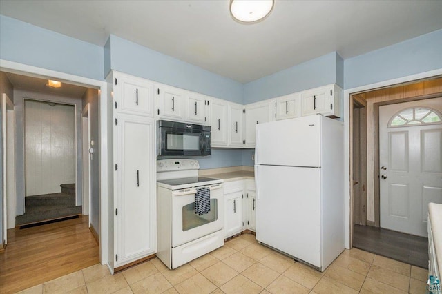 117 W Toledo St, Duluth, MN 55811 - kitchen featuring white appliances, white cabinets, and light tile patterned floors