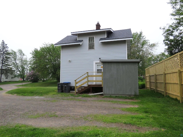 522 S 71st Ave W, Duluth, MN 55807 - rear view of property with roof with shingles and a chimney