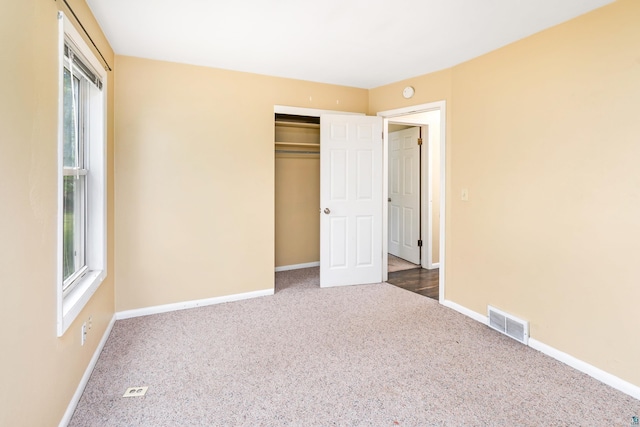 1229 W Arrowhead Rd, Duluth, MN 55804 - unfurnished bedroom featuring carpet flooring, multiple windows, and a closet