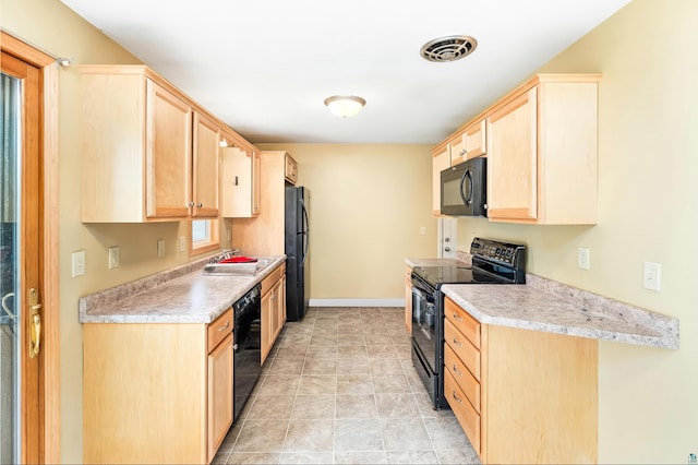 1229 W Arrowhead Rd, Duluth, MN 55804 - kitchen featuring black appliances, light brown cabinetry, and light countertops