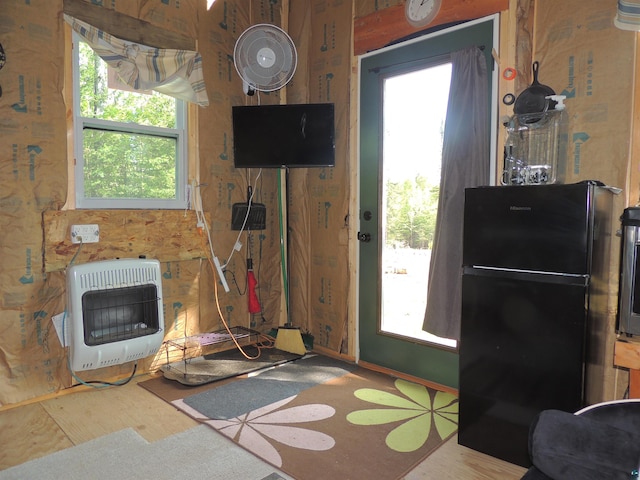 3X Skye Rdg, Grand Marais, MN 55604 - doorway to outside with heating unit, healthy amount of natural light, and wood finished floors