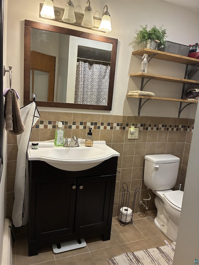722 8th St S, Virginia, MN 55792 - bathroom with vanity, tile walls, tile patterned floors, and a wainscoted wall