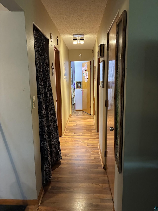 722 8th St S, Virginia, MN 55792 - hall featuring light wood-style floors and a textured ceiling