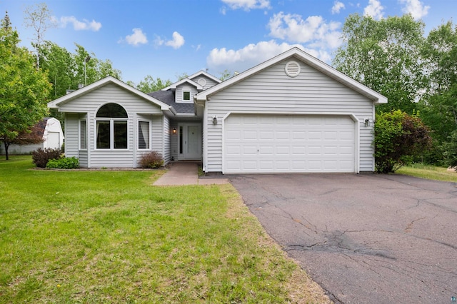 5948 Lavaque Rd, Duluth, MN 55803 - view of front of house featuring asphalt driveway, a front lawn, a shingled roof, and a garage