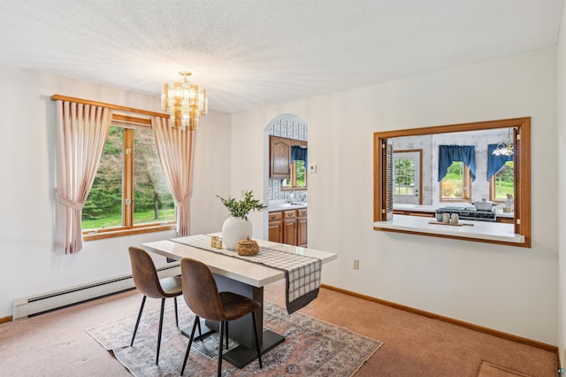 5948 Lavaque Rd, Duluth, MN 55803 - dining room with a baseboard radiator, light colored carpet, a chandelier, and arched walkways