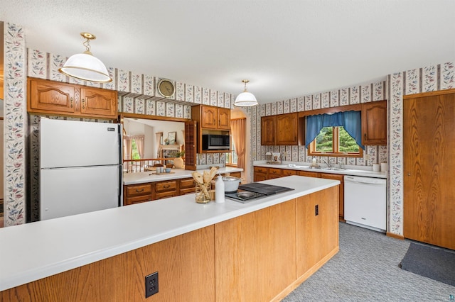 5948 Lavaque Rd, Duluth, MN 55803 - kitchen featuring white appliances, wallpapered walls, light countertops, brown cabinetry, and carpet flooring
