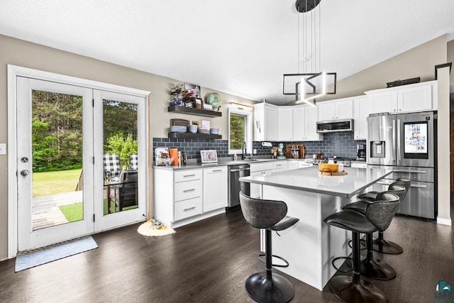 1464 Heather Ln, Cromwell, MN 55726 - kitchen featuring stainless steel appliances, plenty of natural light, tasteful backsplash, and vaulted ceiling