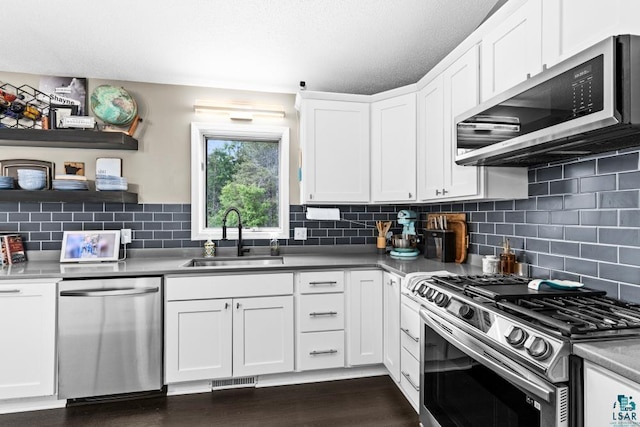 1464 Heather Ln, Cromwell, MN 55726 - kitchen featuring appliances with stainless steel finishes, white cabinets, backsplash, open shelves, and dark wood finished floors