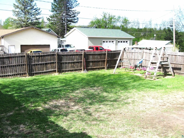 627 4th St, Proctor, MN 55810 - fenced backyard featuring a playground and a garage