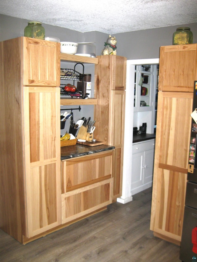 627 4th St, Proctor, MN 55810 - kitchen featuring dark wood-style flooring, dark countertops, and a textured ceiling