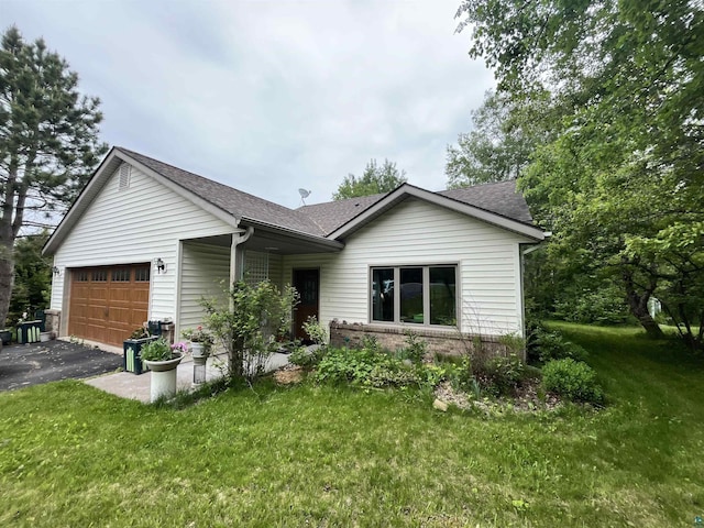 4384 Ugstad Rd, Hermantown, MN 55811 - ranch-style home with a garage, asphalt driveway, roof with shingles, and a front yard