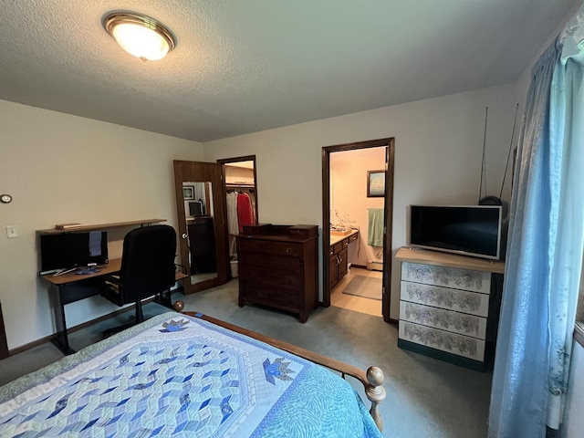 4384 Ugstad Rd, Hermantown, MN 55811 - bedroom with light colored carpet, an office area, ensuite bathroom, a textured ceiling, and a spacious closet