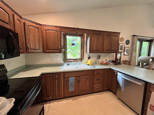 4384 Ugstad Rd, Hermantown, MN 55811 - kitchen with black appliances, vaulted ceiling, healthy amount of natural light, light countertops, and light flooring