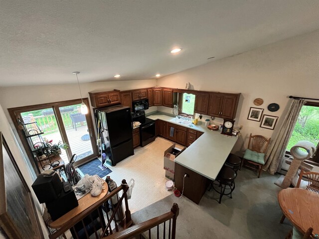 4384 Ugstad Rd, Hermantown, MN 55811 - kitchen featuring black appliances, light carpet, a peninsula, a breakfast bar, and recessed lighting