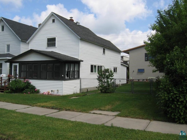 421 E Chapman St, Ely, MN 55731 - view of front of house featuring a sunroom, a chimney, and a shingled roof