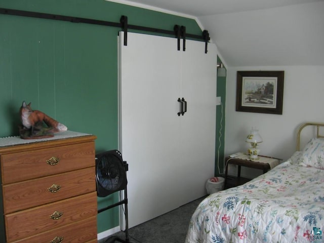421 E Chapman St, Ely, MN 55731 - carpeted bedroom featuring lofted ceiling and a barn door