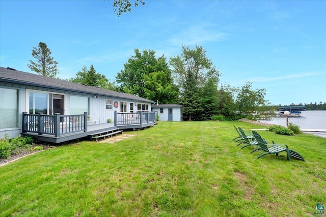 4284 Turner Rd, Duluth, MN 55803 - view of grassy yard with a deck with water view and an outbuilding