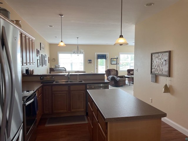 126 W Bayfield St Unit 204, Washburn, WI 54891 - kitchen with stainless steel appliances, dark countertops, a peninsula, dark wood-style floors, and recessed lighting