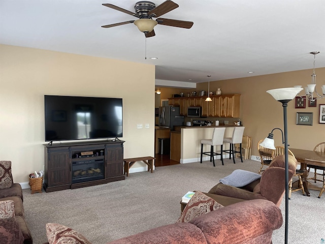 126 W Bayfield St Unit 204, Washburn, WI 54891 - living room featuring light carpet, a ceiling fan, and a chandelier