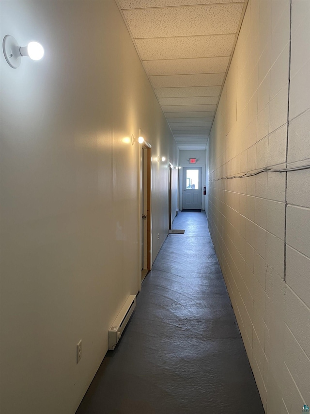126 W Bayfield St Unit 204, Washburn, WI 54891 - hallway with baseboard heating, wood finished floors, and concrete block wall