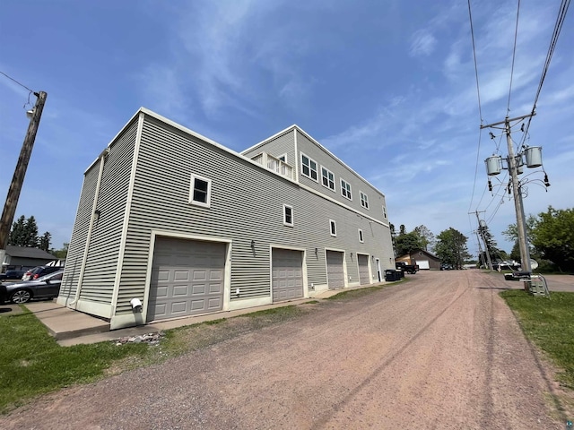 126 W Bayfield St Unit 204, Washburn, WI 54891 - view of home's exterior featuring dirt driveway and a garage