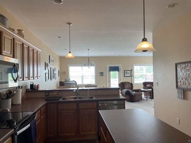126 W Bayfield St Unit 204, Washburn, WI 54891 - kitchen with stainless steel microwave, a peninsula, dark countertops, electric range, and recessed lighting