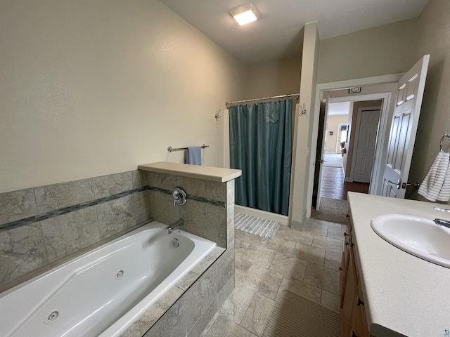 126 W Bayfield St Unit 204, Washburn, WI 54891 - full bathroom featuring a tub with jets, a shower with curtain, vanity, and stone tile floors